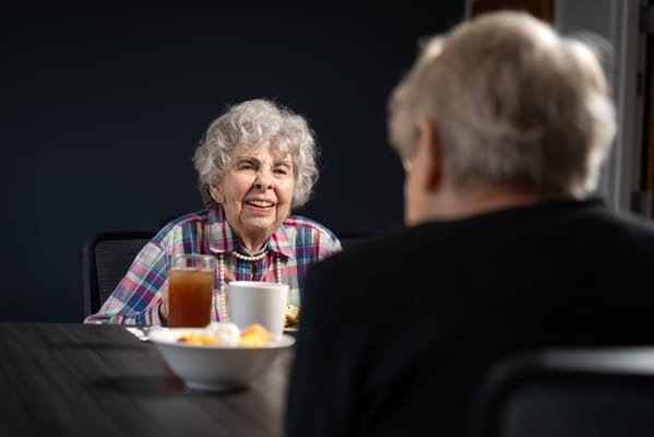 Residents enjoying a meal together at a table