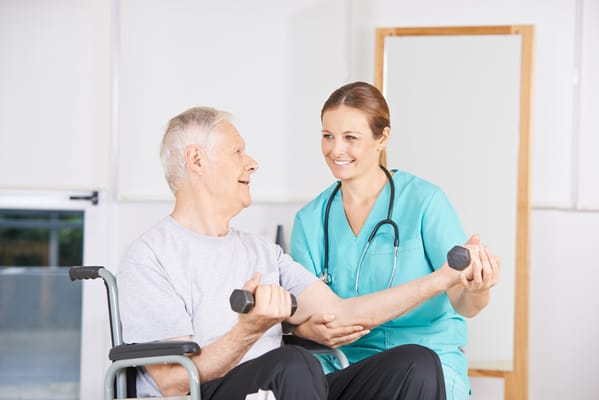 Senior man exercising with a staff member