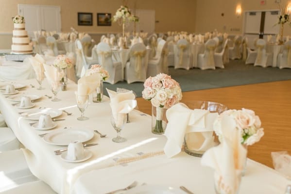 Decorated dining area for an event with floral centerpieces