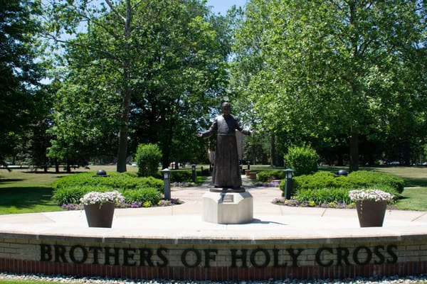 Statue surrounded by lush greenery and gardens