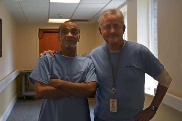 Two staff members in a hallway