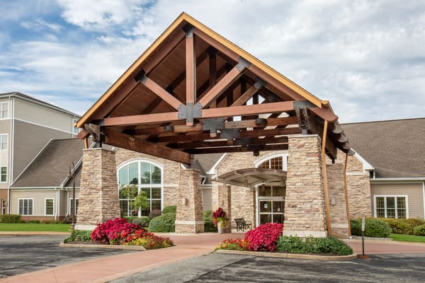 Entrance of a senior living facility with flower arrangements