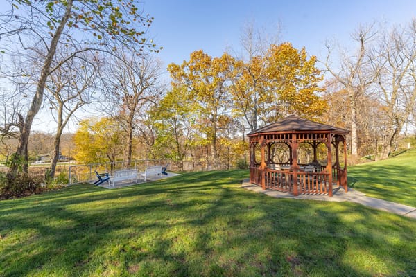 A gazebo in a lush green outdoor area