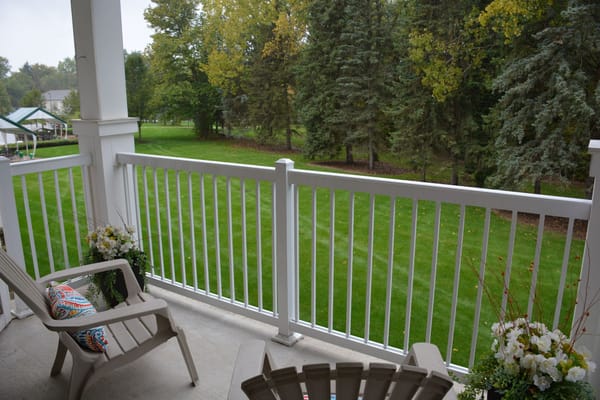 View of a balcony overlooking a grassy area