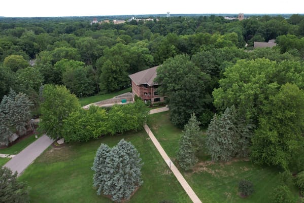 Aerial view of a senior living facility surrounded by trees