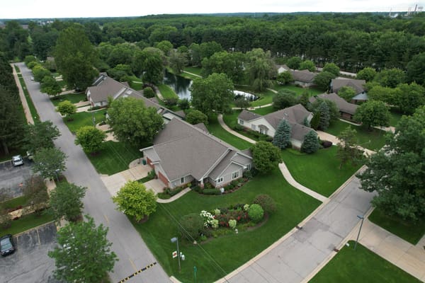 Aerial view of a senior living community with homes and greenery