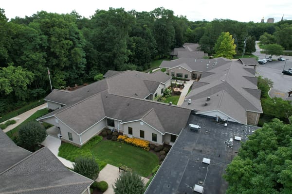 Aerial view of a senior living facility surrounded by greenery