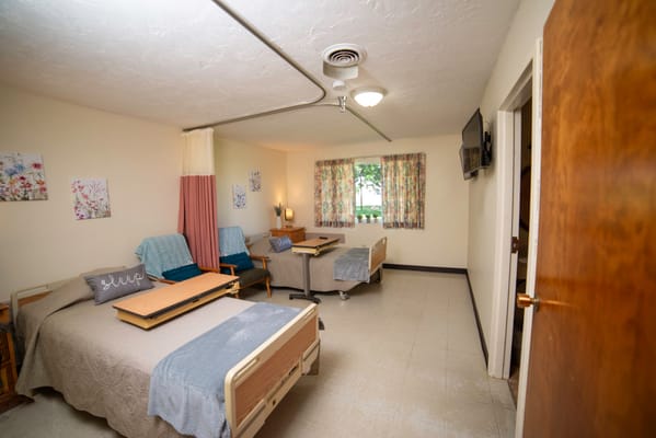Two furnished resident rooms with beds and seating