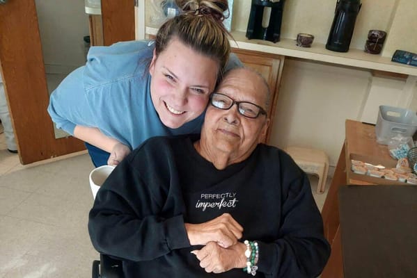 Resident and staff member sharing a warm moment