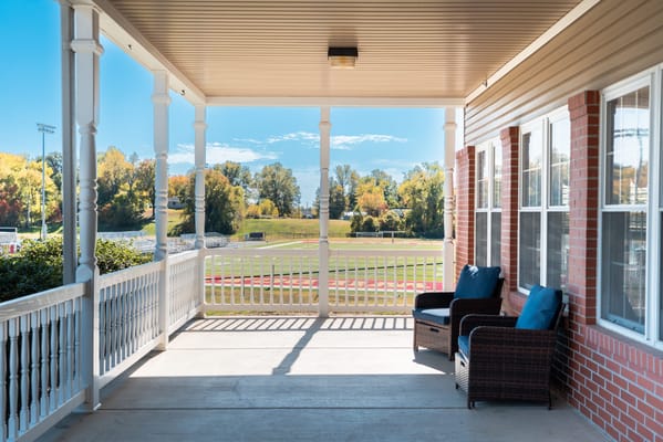 Covered porch area with outdoor seating