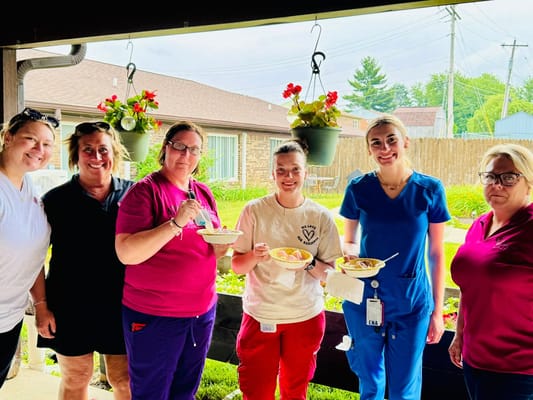 Staff and residents enjoying dessert outside