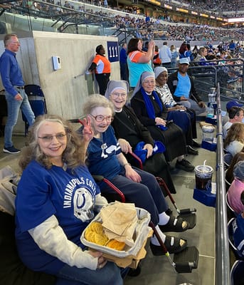 Residents enjoying a football game with snacks