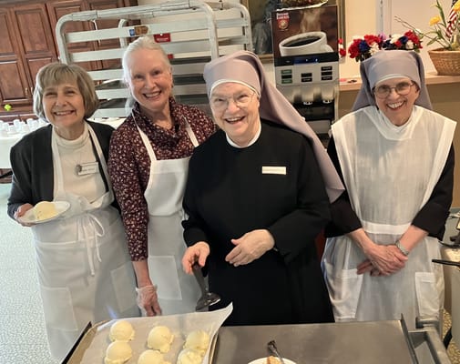 Staff members serving ice cream in a joyful setting