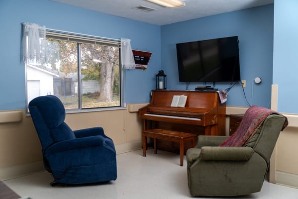 Cozy interior room with chairs and piano