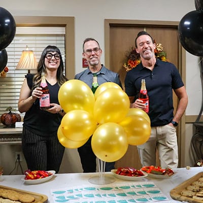Staff and residents celebrating with drinks and balloons
