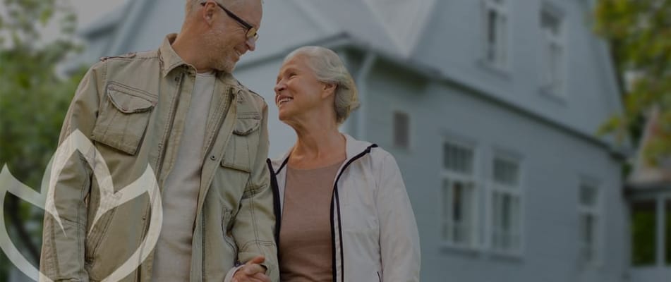 Couple walking outside a senior living facility