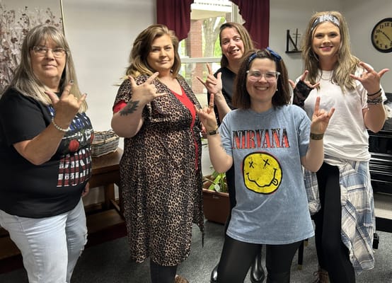 Residents and staff making rock signs in a common area