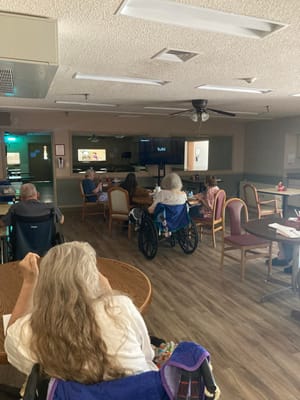 Residents watching a movie in a common area