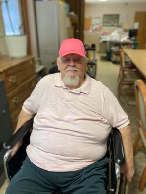 A resident smiling in a facility common area