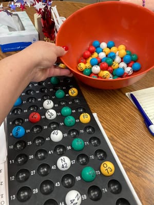 Residents playing bingo with colorful balls