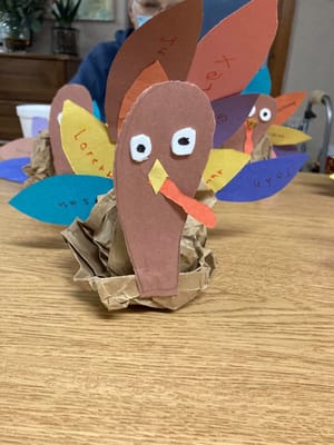 Craft activity with colorful handmade turkey decorations