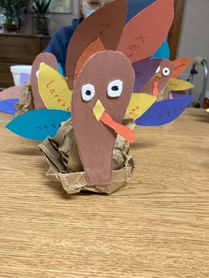 Craft activity with colorful handmade turkey decorations