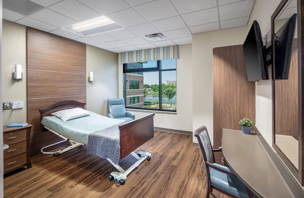 Private resident room with bed and seating area