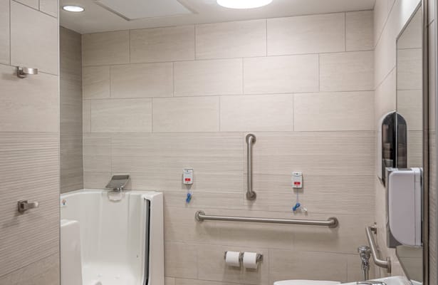 Accessible bathroom with walk-in tub and grab bars