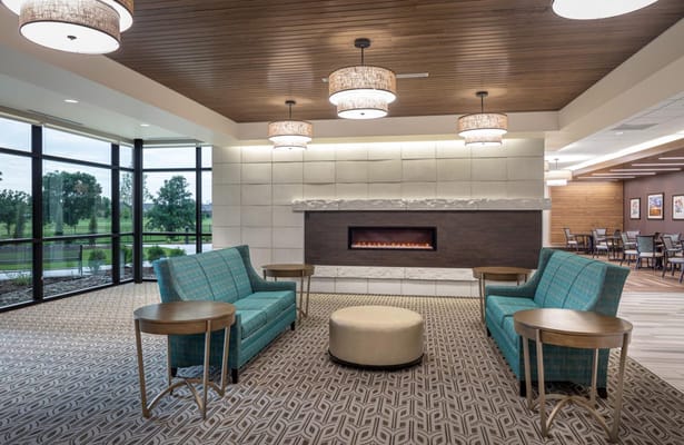 Bright common area with seating and fireplace