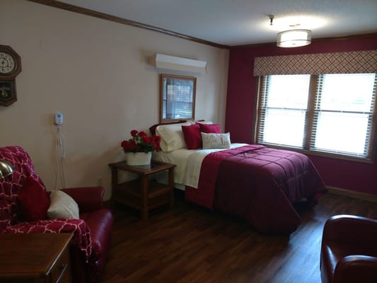 Cozy resident room with red accents and natural light
