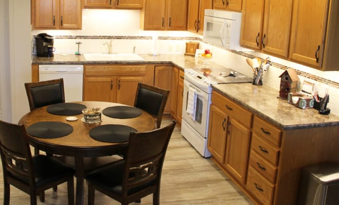 Bright dining area with a round table and kitchen amenities