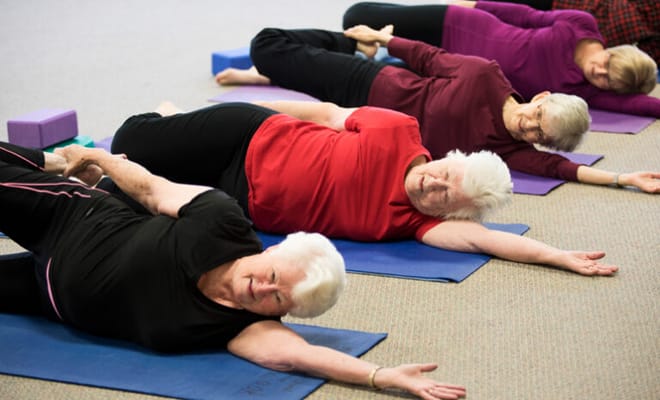 Residents participating in a gentle yoga class