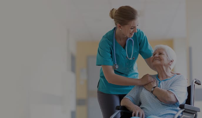 Nurse assisting a resident in a hallway