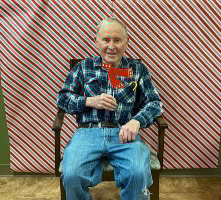 A resident holding a festive decoration in a social setting