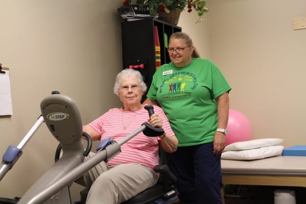Residents engaging in fitness activity with staff assistance