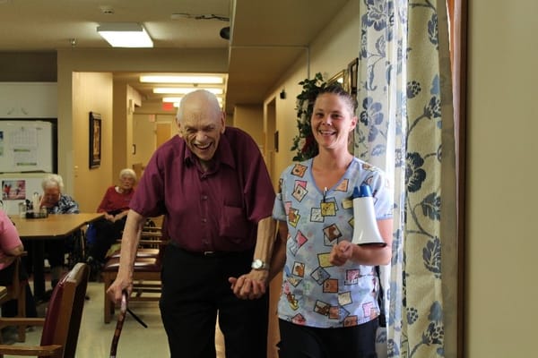 Staff assisting a resident in a common area