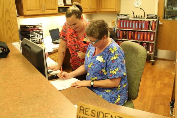 Staff assisting each other at the reception desk
