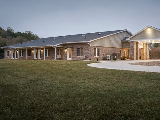 Exterior view of a senior living facility at dusk