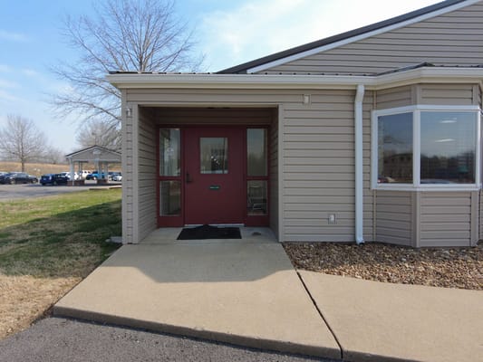 Entrance to a senior living facility with a porch