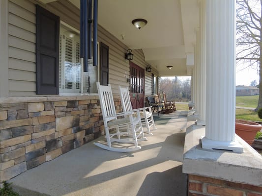 Rocking chairs on a porch of a senior living facility