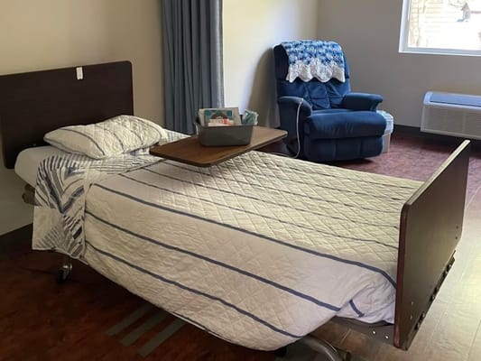 Private room with a bed and seating area