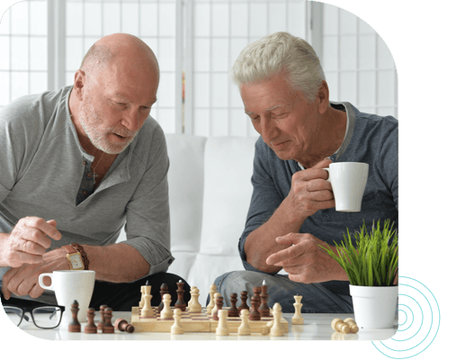 Two residents playing chess in a common area
