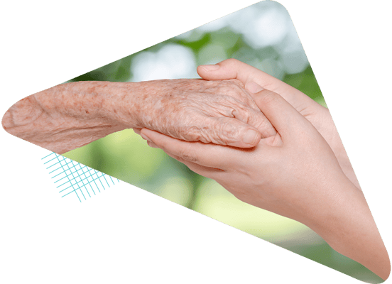 Close-up of a resident holding a caregiver's hand