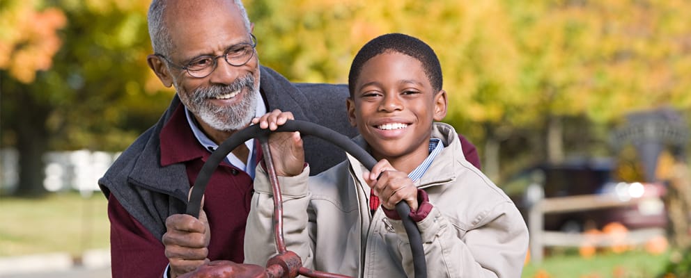 A senior man and a boy enjoying a fun moment outdoors