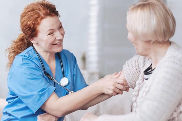 Care staff interacting warmly with a resident