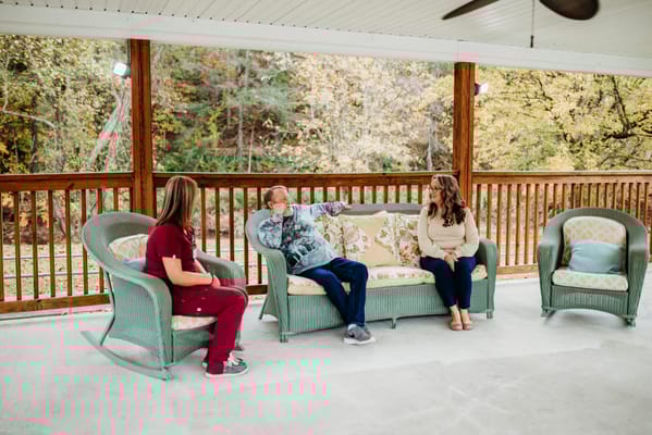 Residents and staff chatting on an outdoor patio