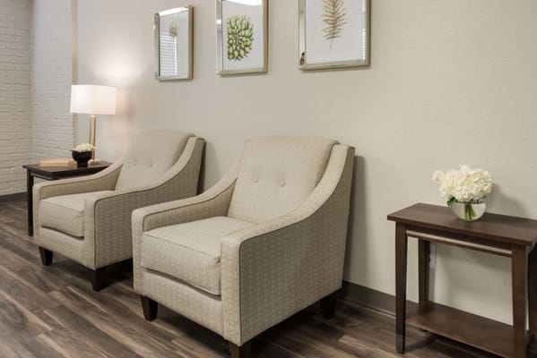 Cozy seating area with two chairs and decorative plants