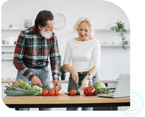 Two residents preparing food in a kitchen
