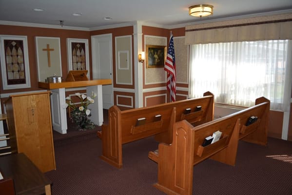 Interior view of a chapel with wooden pews