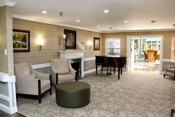 Cozy lounge area with chairs and a piano